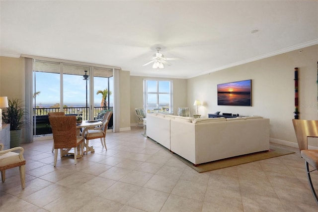 tiled living room with ceiling fan and crown molding