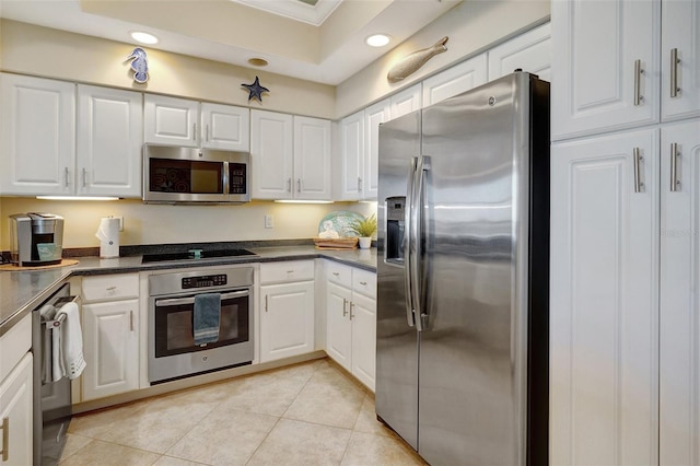 kitchen with light tile patterned flooring, white cabinetry, and appliances with stainless steel finishes