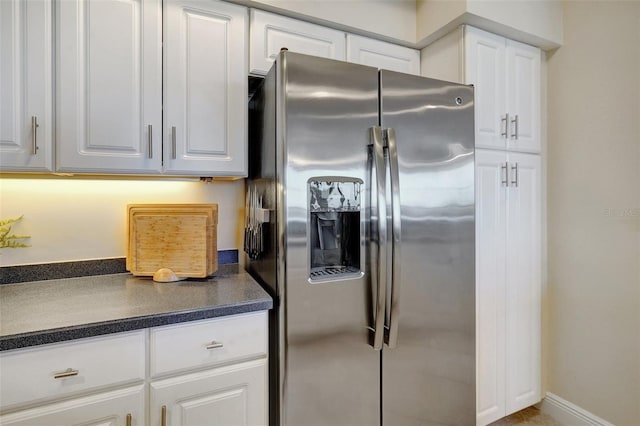 kitchen with white cabinets and stainless steel fridge