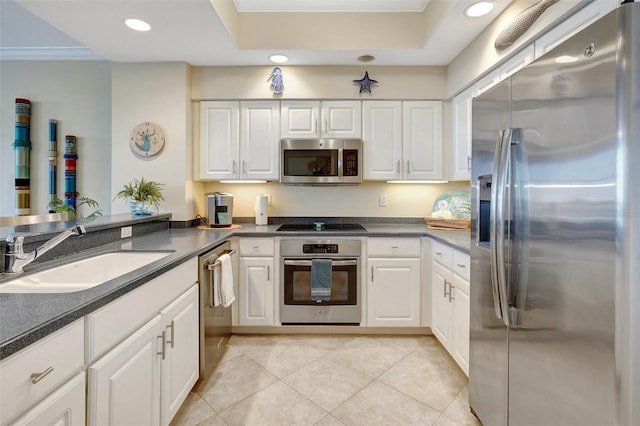 kitchen featuring sink, light tile patterned floors, ornamental molding, white cabinetry, and stainless steel appliances