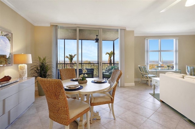 tiled dining space featuring crown molding