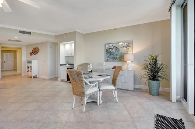 dining area with ceiling fan and ornamental molding