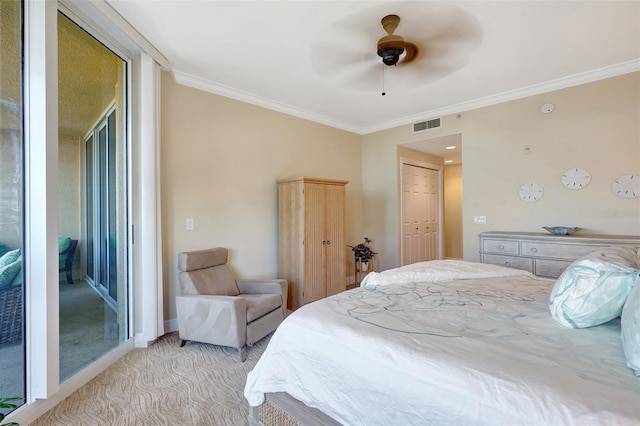 carpeted bedroom with ceiling fan, ornamental molding, and a closet