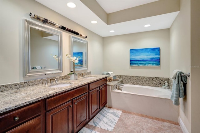 bathroom with vanity, tile patterned floors, and a tub