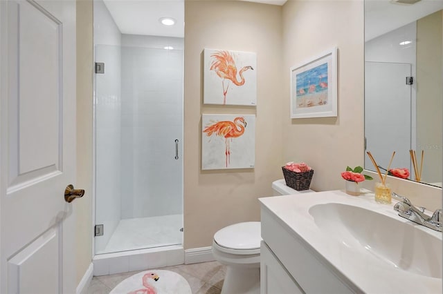 bathroom with tile patterned flooring, vanity, toilet, and walk in shower