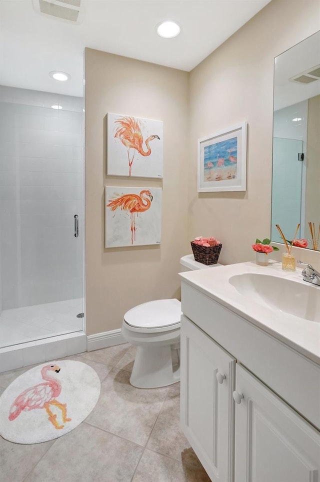 bathroom with tile patterned flooring, vanity, toilet, and a shower with shower door