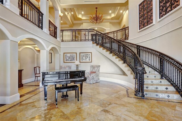 3321 Sunset Key Cir Unit 204, Punta Gorda, FL 33955 - stairway featuring a towering ceiling, marble tiled flooring, crown molding, arched walkways, and recessed lighting