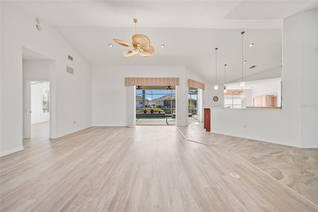 unfurnished living room featuring ceiling fan, light hardwood / wood-style floors, and high vaulted ceiling