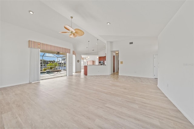 unfurnished living room with light hardwood / wood-style floors, high vaulted ceiling, and ceiling fan