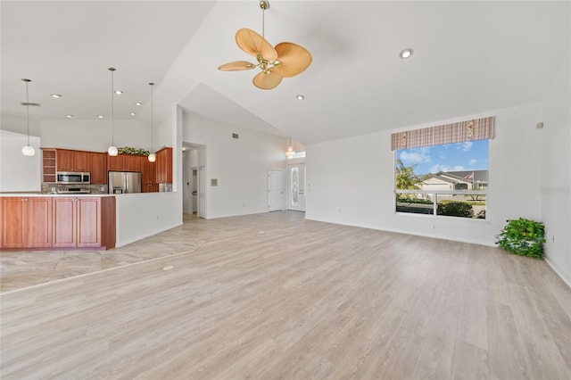 unfurnished living room featuring ceiling fan, high vaulted ceiling, and light wood-type flooring