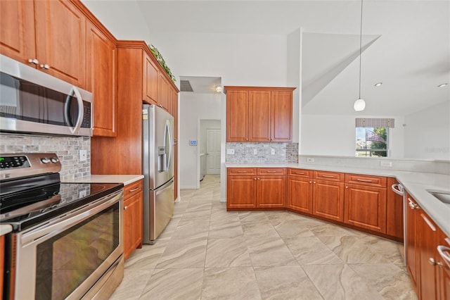 kitchen featuring decorative light fixtures, backsplash, stainless steel appliances, and lofted ceiling