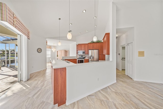 kitchen featuring sink, stainless steel appliances, high vaulted ceiling, kitchen peninsula, and pendant lighting