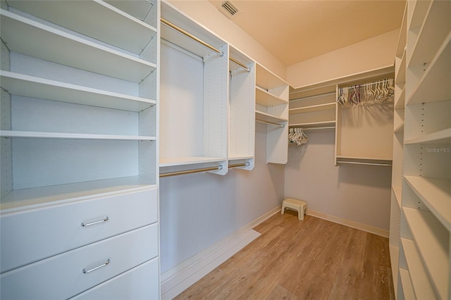 spacious closet featuring light hardwood / wood-style floors