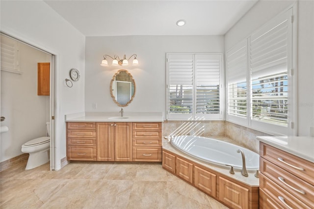 bathroom featuring a tub, vanity, and toilet