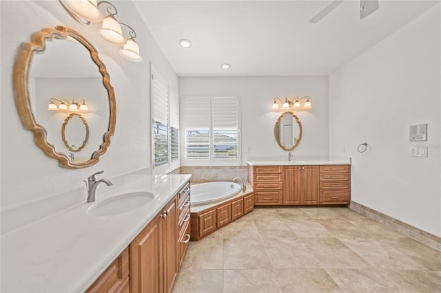 bathroom with a tub, ceiling fan, tile patterned flooring, and vanity