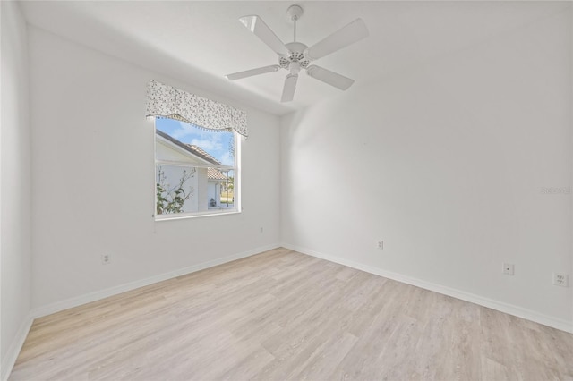 spare room featuring light hardwood / wood-style floors and ceiling fan