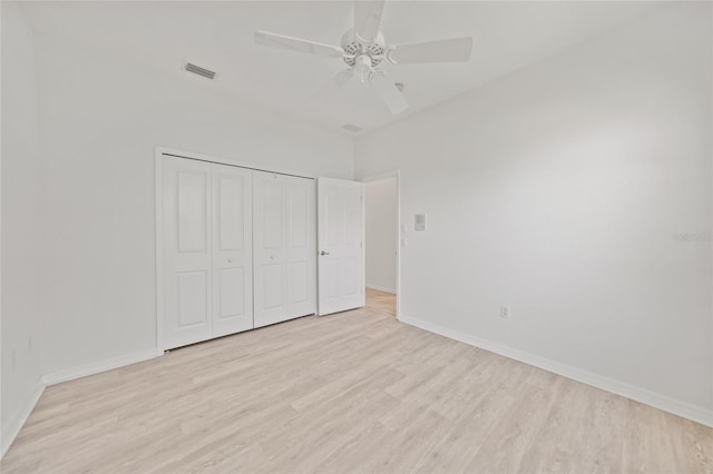 unfurnished bedroom with a closet, light hardwood / wood-style flooring, and ceiling fan