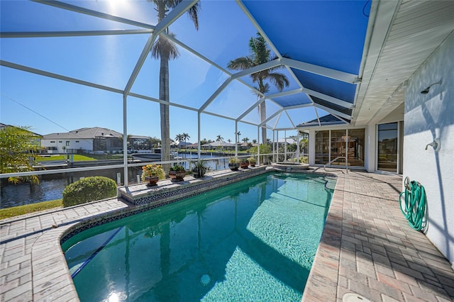 view of swimming pool with a water view, a patio area, and a lanai