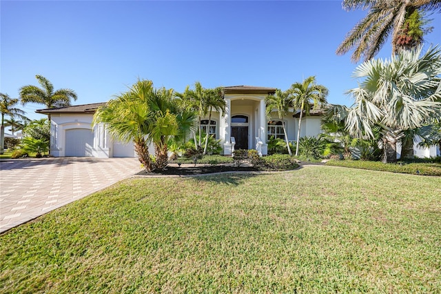 view of front of property with a garage and a front yard