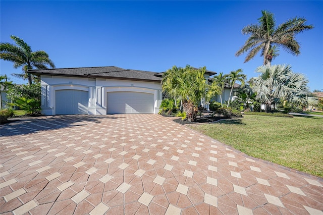 view of front facade featuring a front yard and a garage