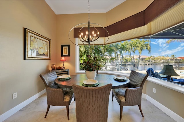 dining space with a water view, light tile patterned floors, and a chandelier