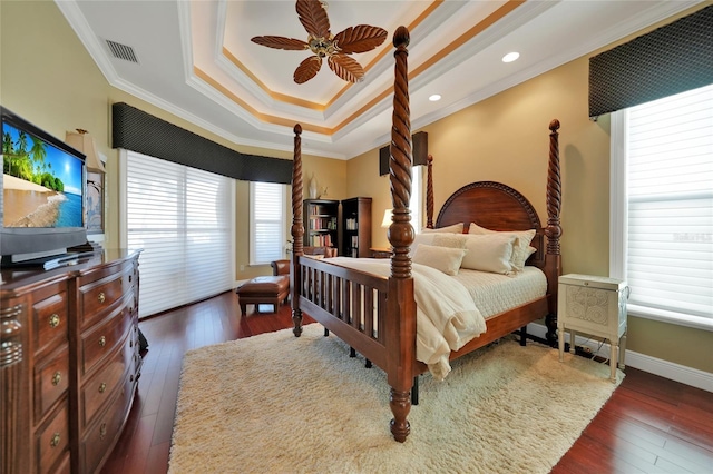 bedroom with ceiling fan, crown molding, and dark wood-type flooring