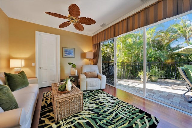 living room with hardwood / wood-style floors, ceiling fan, and crown molding