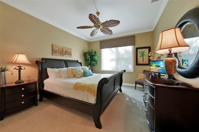 bedroom with ceiling fan, crown molding, and light carpet