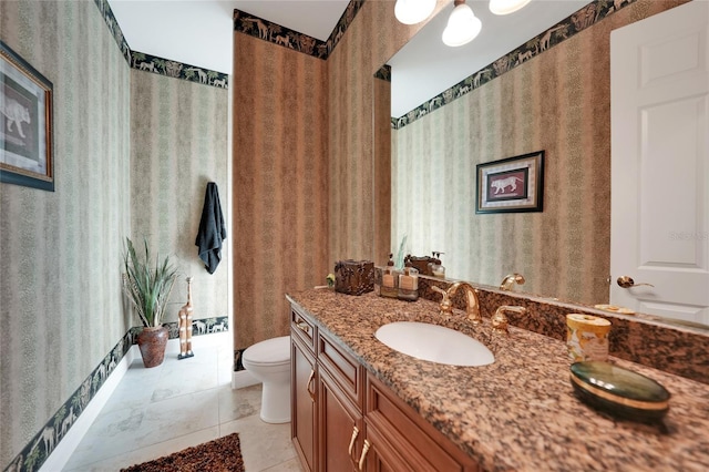 bathroom with tile patterned flooring, vanity, and toilet