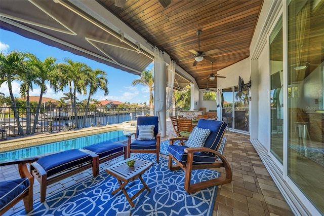 view of patio featuring a fenced in pool, ceiling fan, and a water view