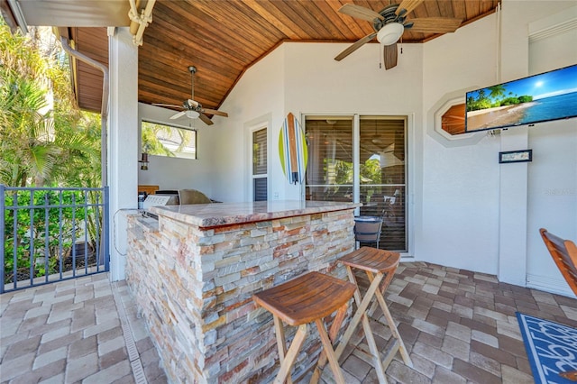 view of patio / terrace with a bar and ceiling fan