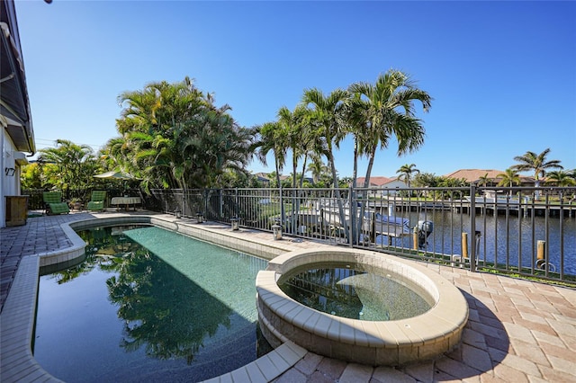 view of pool featuring a patio area and a water view