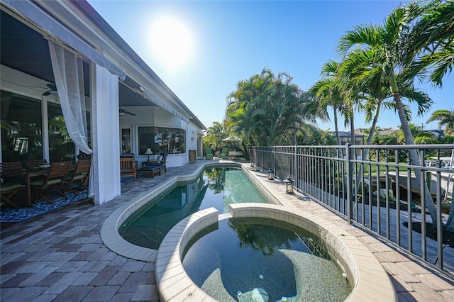 view of swimming pool featuring an in ground hot tub, a patio, and ceiling fan