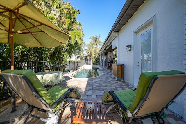 view of patio / terrace with a fenced in pool