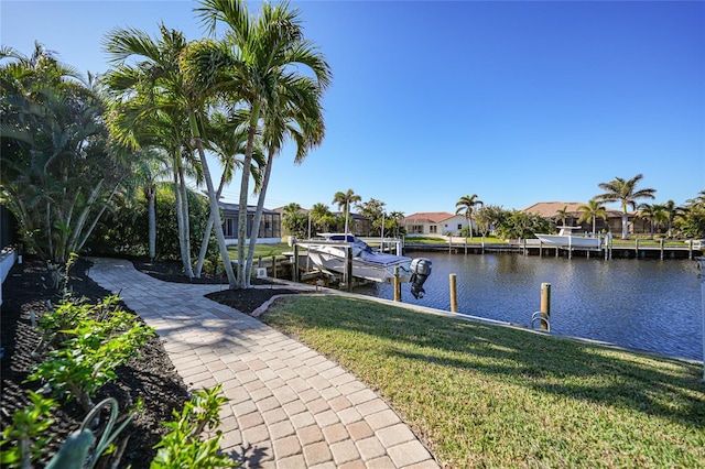 dock area with a yard and a water view