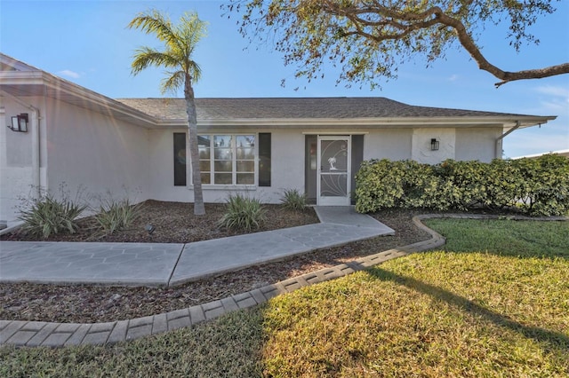 property entrance with a yard