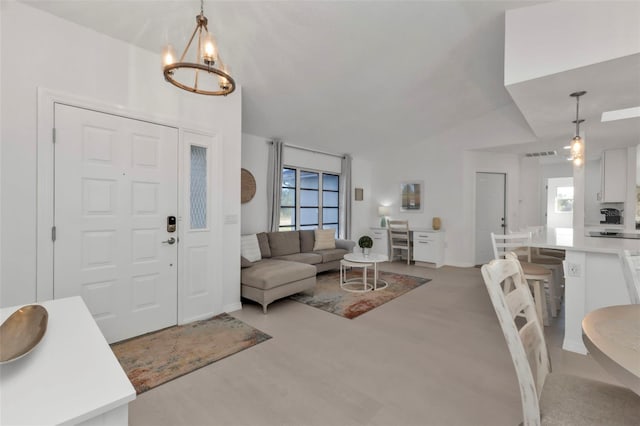 living room with a chandelier, plenty of natural light, and lofted ceiling