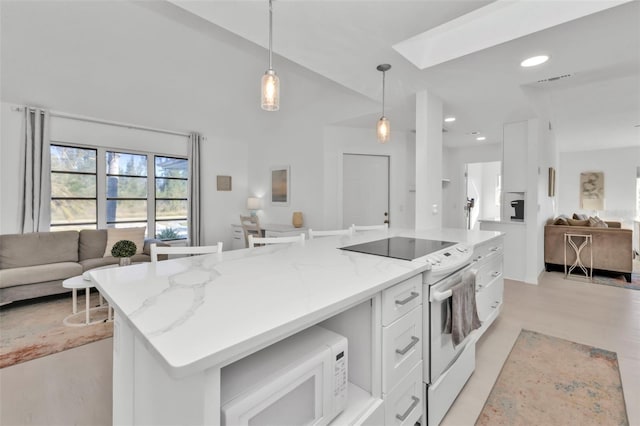 kitchen featuring a center island, white appliances, light stone countertops, decorative light fixtures, and white cabinetry