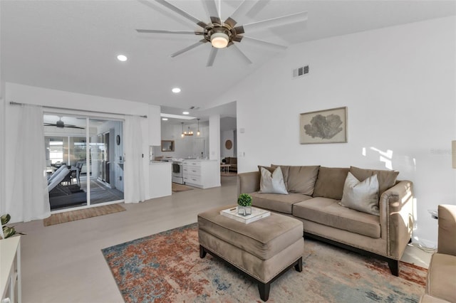 living room with ceiling fan, light hardwood / wood-style flooring, and vaulted ceiling