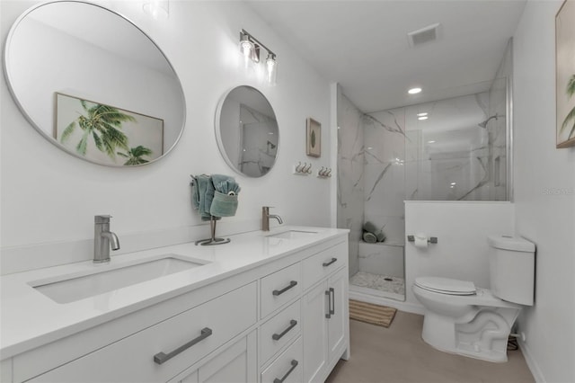 bathroom featuring tiled shower, vanity, and toilet