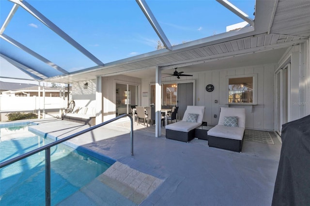 view of swimming pool featuring a lanai, a patio area, and ceiling fan