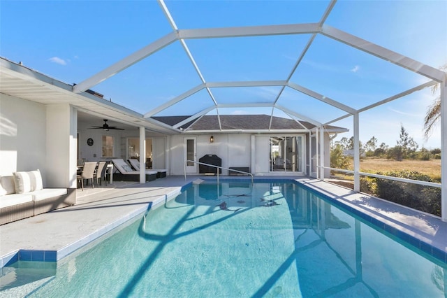 view of pool with a patio area, an outdoor living space, ceiling fan, and glass enclosure