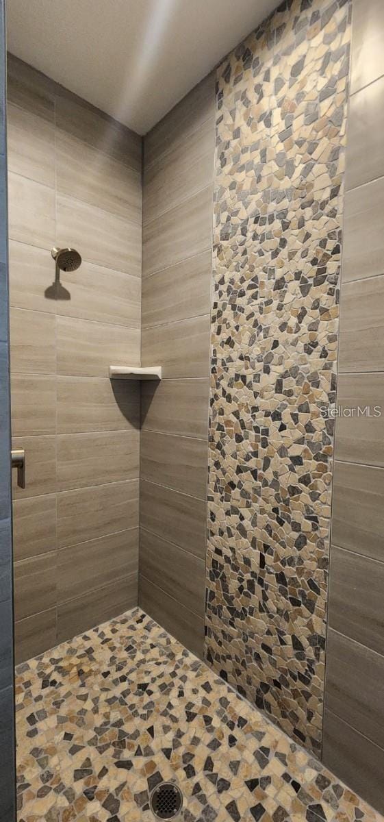 bathroom with tiled shower