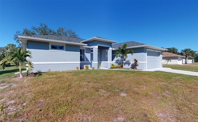 view of front of property with a garage and a front yard