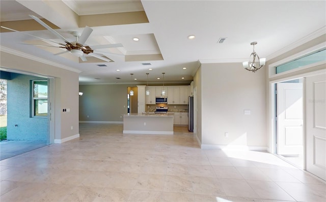 unfurnished living room featuring ceiling fan with notable chandelier, a tray ceiling, crown molding, and sink