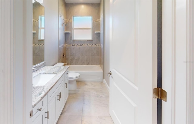 full bathroom featuring toilet, vanity, and tiled shower / bath