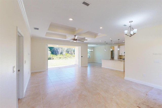 tiled empty room with a tray ceiling, coffered ceiling, ceiling fan with notable chandelier, and ornamental molding