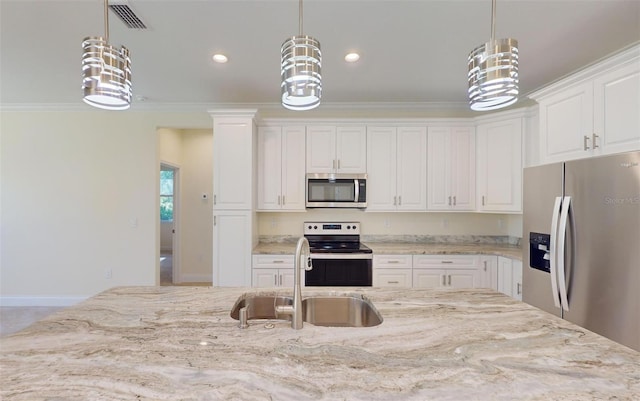 kitchen featuring sink, white cabinets, pendant lighting, and appliances with stainless steel finishes