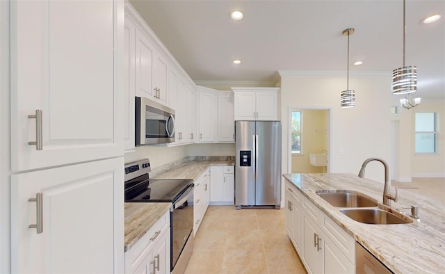 kitchen with light stone countertops, sink, appliances with stainless steel finishes, white cabinets, and ornamental molding