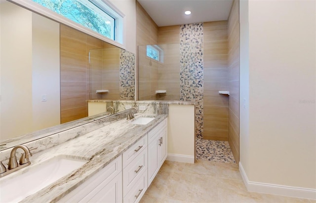 bathroom featuring tiled shower, vanity, and tile patterned floors